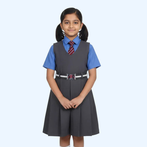 Girl wearing a gray vest and blue shirt with a red tie on a light blue background