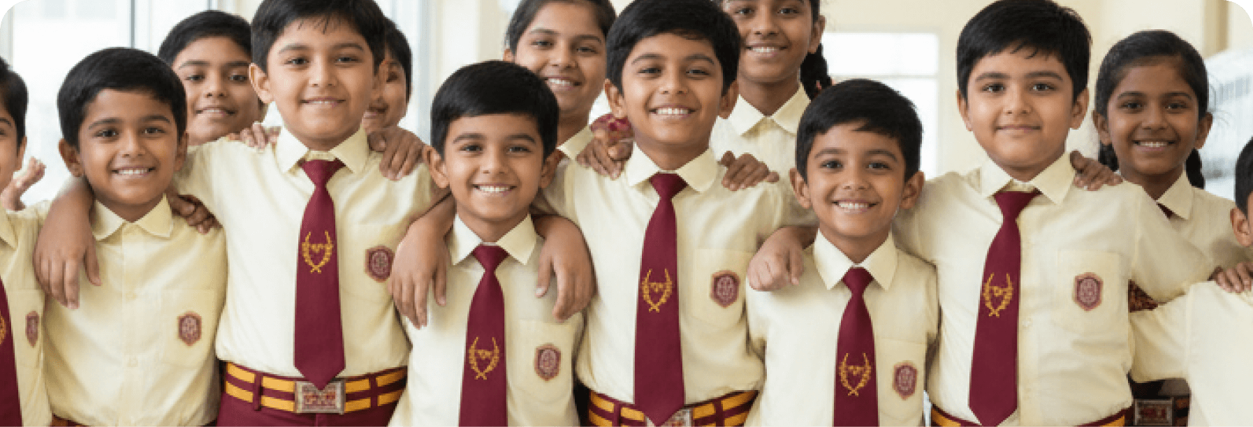 Group of boys in school uniforms with red ties and badges.